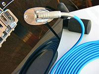 Canare GS-6 Guitar/instrument Cable with blue jacket connected to a guitar with a Canare F-15 1/4" TS plug